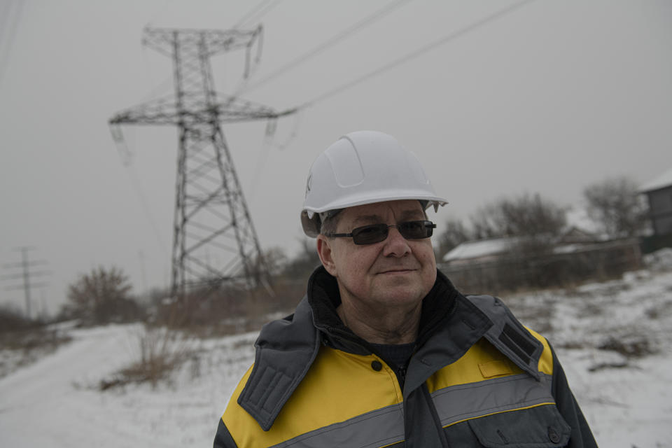 Foreman of DTEK Oleh Braharnyk gives an interview as he carries out the maintenance of power lines in Kyiv, Ukraine, Thursday, Dec. 8, 2022. Ukrainian utility crews struggling to patch up power lines during a two-month Russian military blitz targeting Ukrainian infrastructure are learning to adapt. And just as on the battlefield, Ukrainians are learning to respond quickly on the new energy front drawn inside homes, hospitals, offices, and schools in yet another act of defiance against a powerful invader. (AP Photo/Andrew Kravchenko)