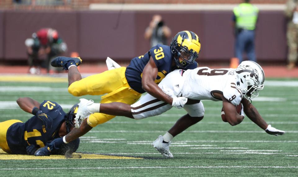 Michigan Wolverines defensive back Daxton Hill tackles Western Michigan Broncos running back Sean Tyler during the second half Saturday, Sept. 4, 2021.