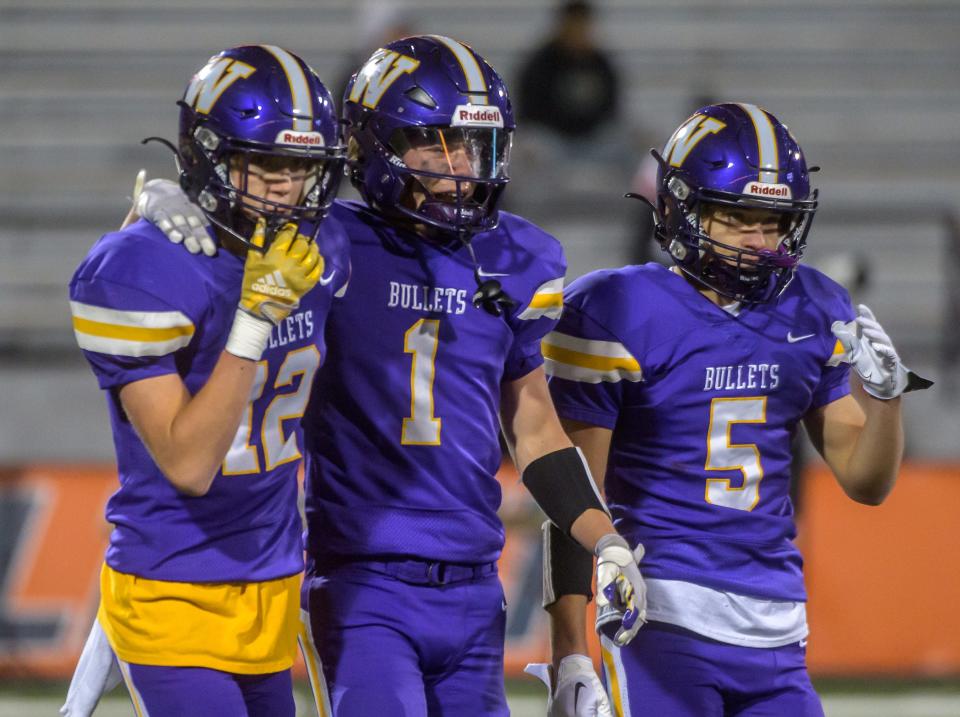Williamsville's Gage Knoles (12), Nolan Bates (1) and Luke Vaughn walk off the field after their 48-17 loss to IC Catholic in the Class 3A football state title game Friday, Nov. 25, 2022 in Champaign.