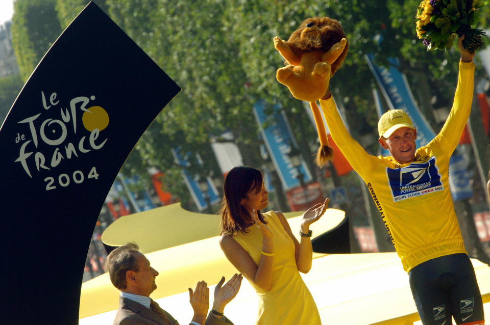 PARIS, France:  US Lance Armstrong (US Postal/USA) celebrates on the podium with his yellow jersey after he won the 91st Tour de France cycling race on the Champs-Elysees in Paris, 25 July 2004. Armstrong won a record-setting sixth Tour de France leaving him as the race's biggest champion in it's 101-year history.    AFP PHOTO   MARTIN BUREAU  (Photo credit should read MARTIN BUREAU/AFP/Getty Images)