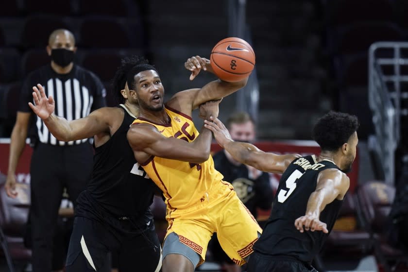 Southern California's Evan Mobley, center, is fouled by Colorado's D'Shawn Schwartz.