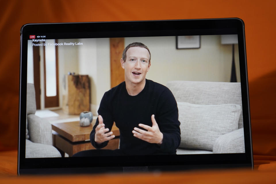 Seen on the screen of a device in Sausalito, Calif., Facebook CEO Mark Zuckerberg delivers the keynote address during a virtual event on Thursday, Oct. 28, 2021. Zuckerberg talked up his latest passion -- creating a virtual reality "metaverse" for business, entertainment and meaningful social interactions. (AP Photo/Eric Risberg)