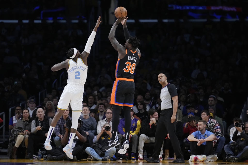 New York Knicks forward Julius Randle (30) shoots over Los Angeles Lakers forward Jarred Vanderbilt (2) during the first half of an NBA basketball game Sunday, March 12, 2023, in Los Angeles. (AP Photo/Marcio Jose Sanchez)