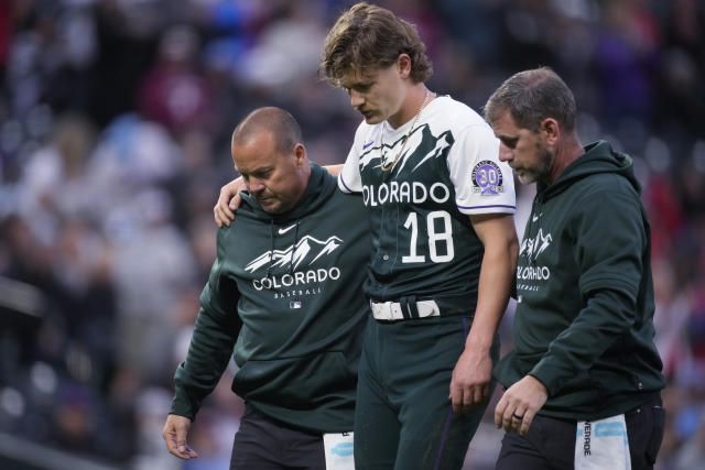 Trainers led Rockies pitcher Ryan Feltner off the field after he was struck by a ball during the second inning against the Philadelphia Phillies on Saturday in Denver. (AP Photo/David Zalubowski)