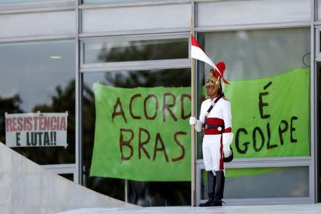 Posters placed by supporters of Brazilian President Dilma Rousseff are pictured at the Planalto Palace after a ceremony to announce the creation of new public universities, in Brasilia, Brazil, May 9, 2016. REUTERS/Ueslei Marcelino