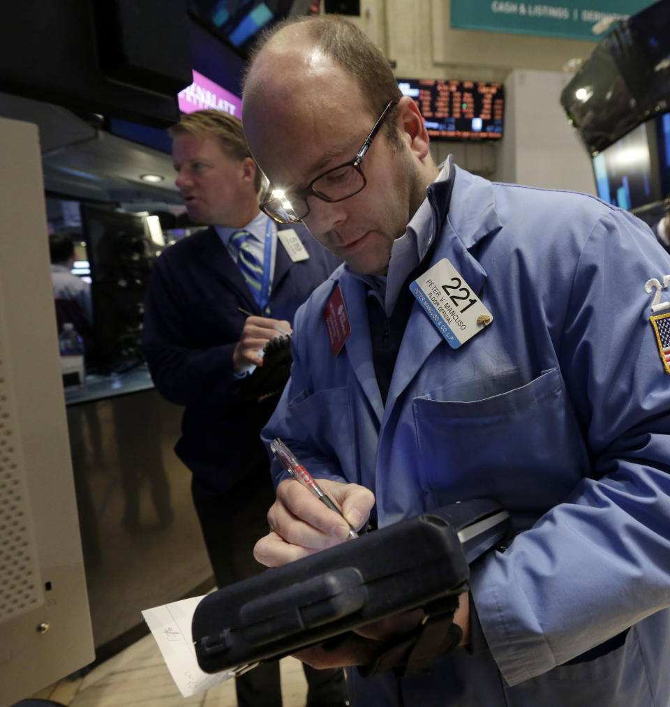 Traders John Bowers, left, and Peter Mancuso work on the floor of the New York Stock Exchange Wednesday, Jan. 8, 2014.Stocks are mostly lower in early trading as investors hold back ahead of the release of the latest news from the Federal Reserve. (AP Photo/Richard Drew)