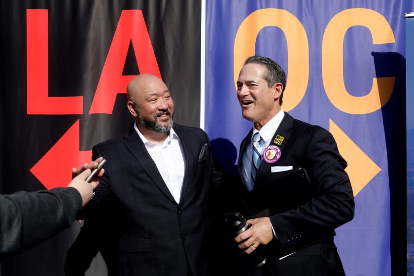 LA PALMA, CA - JANUARY 26: Orange County District Attorney Todd Spitzer, right, shown with a supporter, left, after a press conference to kick off Spitzer's re-election campaign at El Rancho Verde park on Wednesday, Jan. 26, 2022 in La Palma, CA. The DA's race, which has only two candidates-Todd Spitzer and former OC prosecutor Pete Hardin. (Gary Coronado / Los Angeles Times)