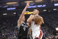 Sacramento Kings guard Kevin Huerter (9) guards Miami Heat guard Tyler Herro (14) during the first quarter of an NBA basketball game in Sacramento, Calif., Saturday, Oct. 29, 2022. (AP Photo/Randall Benton)