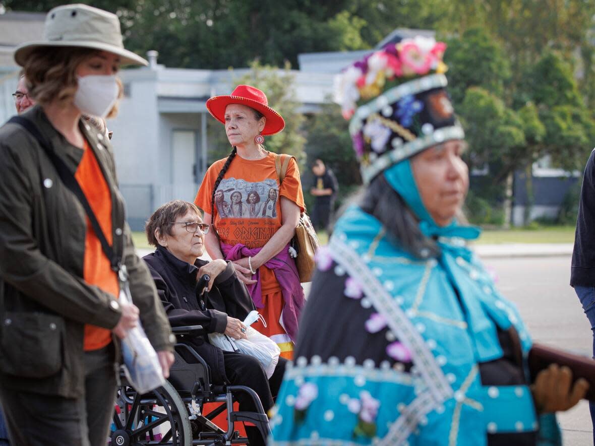 Attendees to an outdoor mass presided over by Pope Francis line up outside Commonwealth Stadium in Edmonton on July 26, 2022. (Evan Mitsui/CBC - image credit)