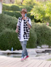 In between hanging out with his crew including the Jenner sisters, Hailey Baldwin, and Nash Grier, Justin Bieber took a phone call wearing a Nick Fouquet hat, distressed denim pants, a sleeveless gingham shirt, and red sneakers.