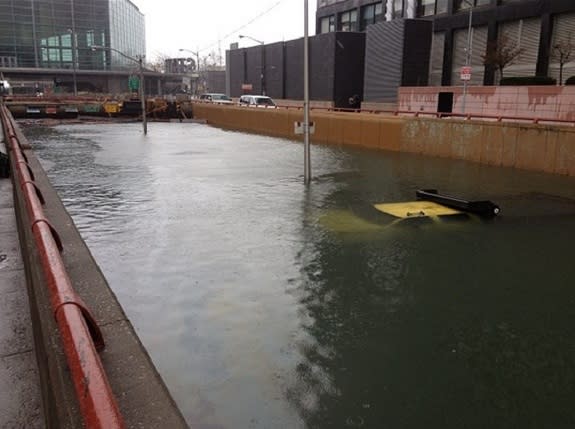 Entrance to Battery Park flooded, NYC DOT truck seen submerged, blocking entrance after early closure on Oct. 29.