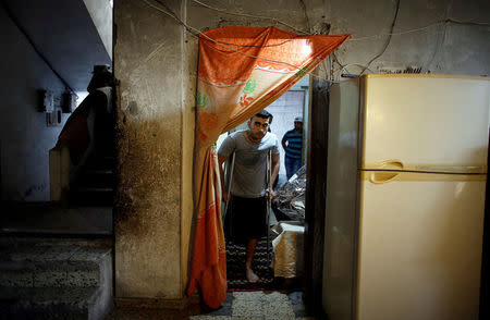 Palestinian cyclist Alaa Al-Daly, 21, who lost his leg by a bullet fired by Israeli troops, arrives to his house in Rafah, southern Gaza Strip, April 18, 2018. REUTERS/Suhaib Salem