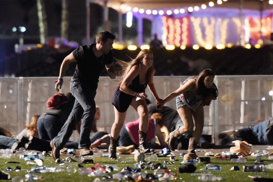 People run from gunfire at the Route 91 Harvest country music festival Oct. 1, 2017, in Las Vegas.