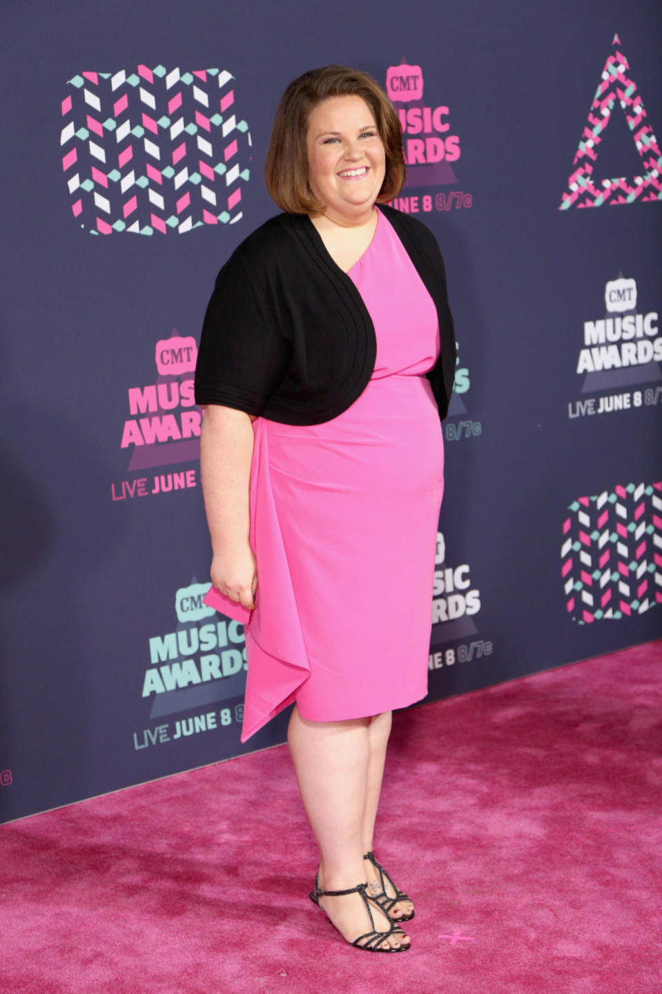 Chewbacca Mom, otherwise known as Candace Payne, wearing a bubblegum pink dress with a black shrug 