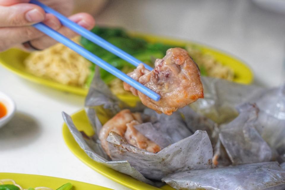 chopstick picking up piece of chicken