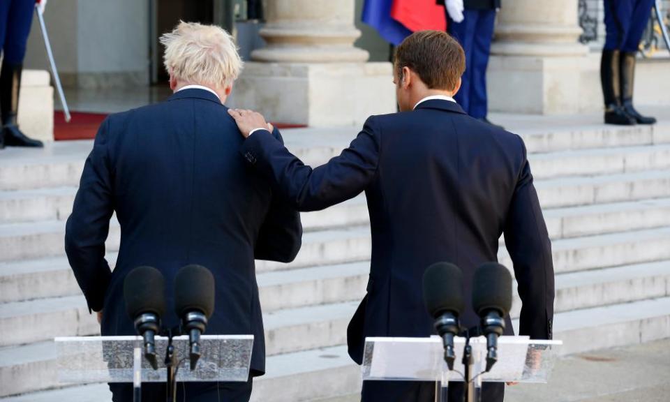 Macron pats Johnson on the shoulder