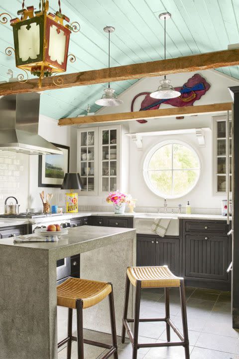 kitchen with sky blue ceiling and dark gray lower cabinets with beadboard fronts