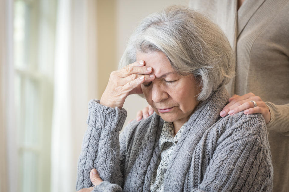 Close up of daughter comforting pained mother