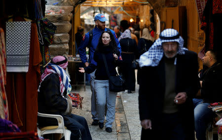 A member of the Temporary International Presence in Hebron (TIPH) gestures as she walks in the old city of Hebron, in the Israeli-occupied West Bank January 29, 2019. REUTERS/Mussa Qawasma