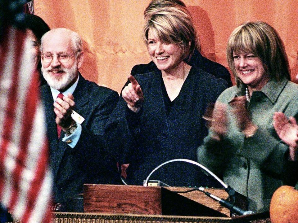 Martha Stewart (C) ringing the opening bell to begin trading at the New York Stock Exchange on October 19, 1999.