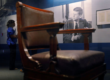 Curator Stacey Bredhoff stands behind John F. Kennedy's chair from the U.S. Senate, part of the exhibit "JFK 100," marking the 100th anniversary of Kennedy's birth May 29, at the John F. Kennedy Presidential Library in Boston, Massachusetts, U.S., May 19, 2017. REUTERS/Brian Snyder