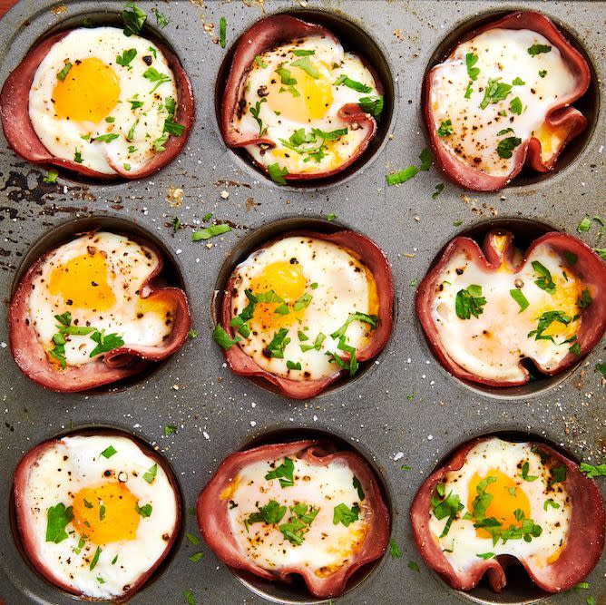 <p>This low carb breakfast comes together in no time—seriously, you only need 20-ish minutes! If you like your eggs super runny, you might want to pull them from the oven a minute before you think they're ready. You'll need to let them rest for a bit in the muffin tin before taking them out (they'll be HOT), and during these few minutes, the eggs will continue to cook slightly.</p><p>Get the <a href="https://www.delish.com/uk/cooking/recipes/a29030029/ham-cheese-egg-cups-recipe/" rel="nofollow noopener" target="_blank" data-ylk="slk:Ham & Cheese Egg Cups;elm:context_link;itc:0;sec:content-canvas" class="link ">Ham & Cheese Egg Cups</a> recipe. </p>