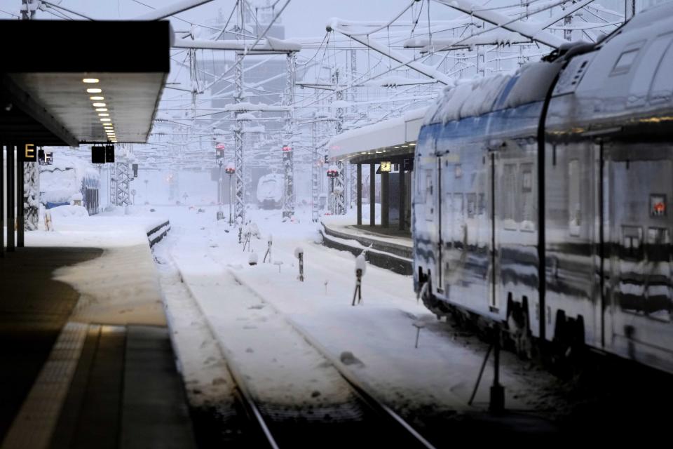 Snow covered trains are parked at the central station after heavy snow fall in Munich, Germany, Saturday, Dec. 2, 2023. (AP Photo/Matthias Schrader)