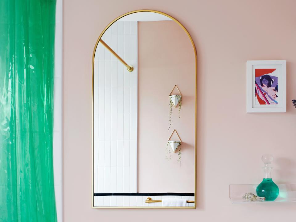 bathroom with pink wall behind vanity