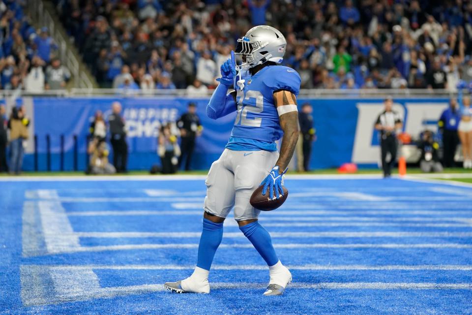 Lions running back D'Andre Swift gestures to the fans after rushing for a 17-yard touchdown during the first half Jan. 1, 2023 against the Bears in Detroit.
