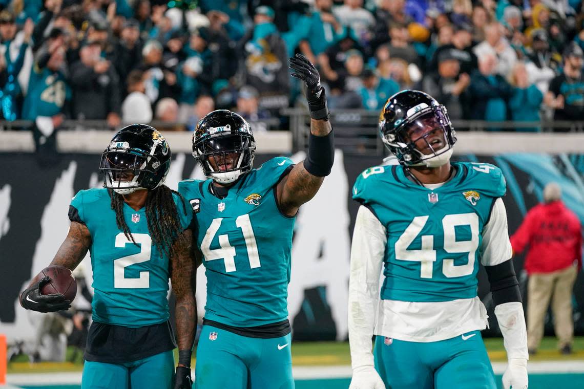 Jacksonville Jaguars linebacker Josh Allen (41) and safety Rayshawn Jenkins (2) celebrate during last weekend’s playoff berth-clinching win over Tennessee.