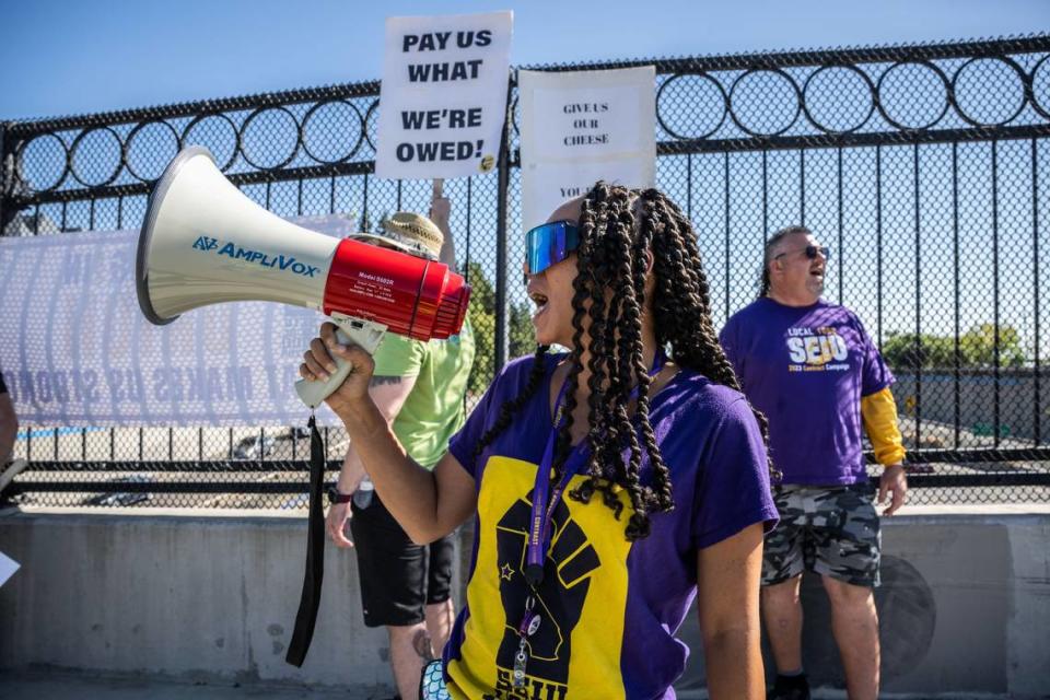 Krystal Coles, an SEIU Local 1000 member, rallies on the O Street bridge over Interstate 5 in downtown Sacramento on Aug. 3, 2023, as members of the California Association of Professional Scientists joined for a banner drop. Many state workers are unhappy about Local 1000’s tentative agreement with the state. But they expect it to pass anyway, even if they vote “no.”
