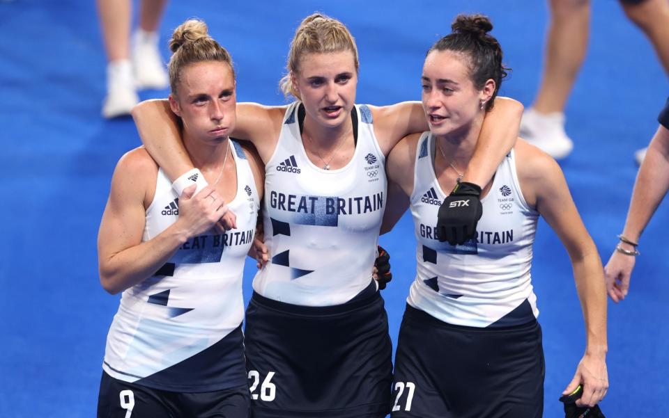 Susannah Townsend, Lily Owsley and Fiona Anne Crackles of Team Great Britain leave the pitch following victory over Spain - GETTY IMAGES