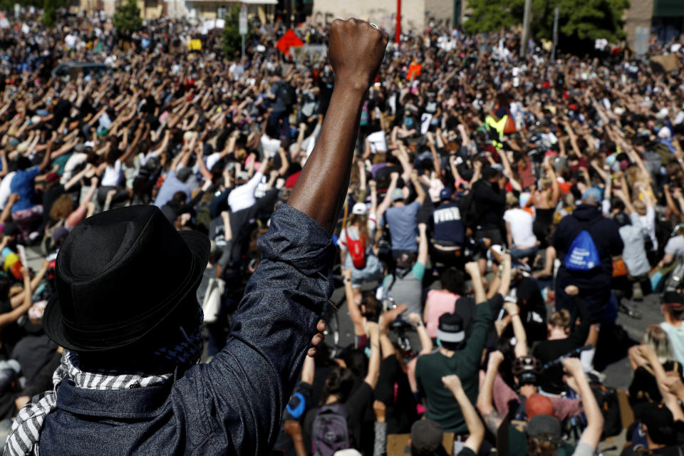 Image: Protesters raise their fist during a demonstration in Minneapolis on May 30, 2020. (John Minchillo / AP)