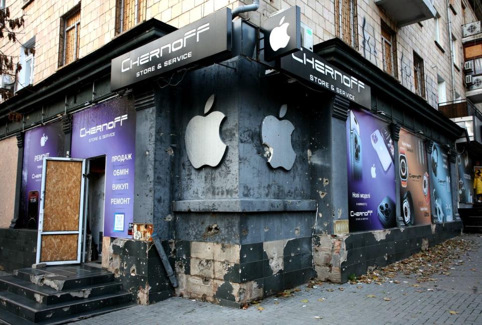 A damaged electronics store in Mykolaiv. Denmark provided wooden panels to replace destroyed windows in preparation for winter. (Dominic Culverwell/ The Kyiv Independent)
