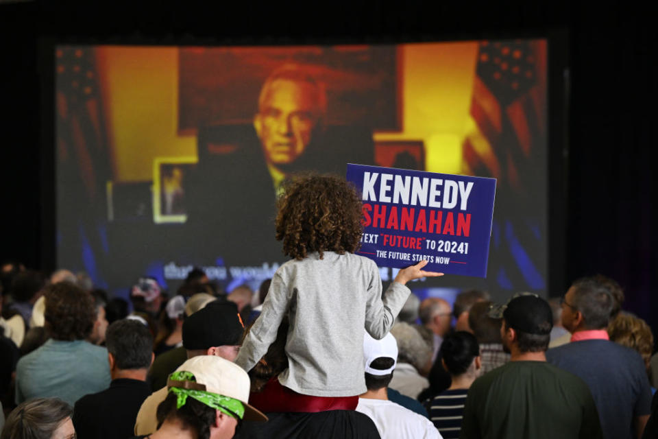 Sage Murray, 8, sits on the shoulders of her father Ben as they watch a video produced for and by independent presidential candidate Robert F. Kennedy Jr. before he spoke during a voter rally in Aurora, Colorado, on May 19, 2024. (Photo by Helen H. Richardson/MediaNews Group/The Denver Post via Getty Images)