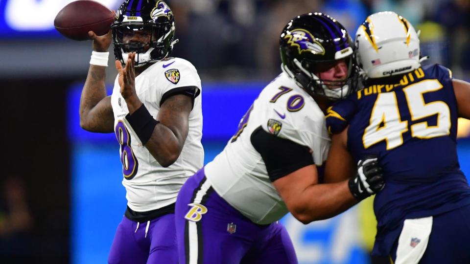 Nov 26, 2023; Inglewood, California, USA; Baltimore Ravens quarterback Lamar Jackson (8) throws as guard Kevin Zeitler (70) provides coverage against Los Angeles Chargers linebacker Tuli Tuipulotu (45) during the first half at SoFi Stadium.