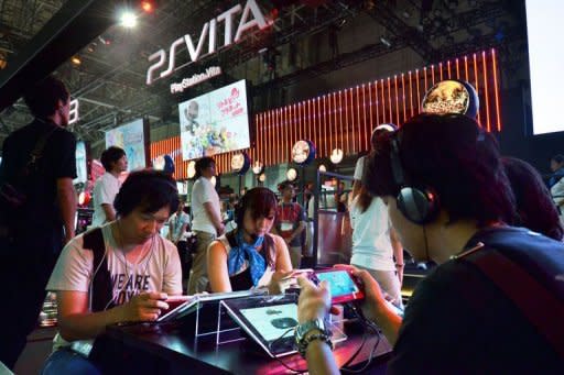 Visitors play Sony Computer Entertainment's game consoles at the annual Tokyo Game Show in Chiba, suburban Tokyo. Some 200 companies exhibited their latest video game hardware and software with some 200,000 people expected to visit the four-day vent