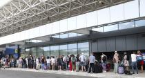 British tourists wait in a queue at the Ioannis Kapodistrias Airport in Corfu island, northwestern Greece, Monday, Sept. 23, 2019. Hundreds of thousands of travellers were stranded across the world Monday after British tour company Thomas Cook collapsed, immediately halting almost all its flights and hotel services and laying off all its employees. (Stamatis Katopodis/InTime News via AP)