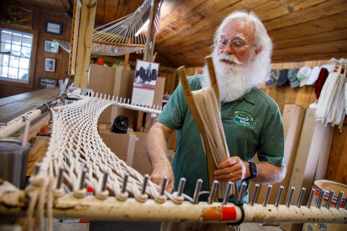 Harry Woodbury, a hammock maker of 25 years, weaves a Pawleys Island hammock from 1300 feet of rope. The Pawleys Island Original Hammock Shop opened in 1935 by the family of riverboat captain Joshua John Ward who pioneered the use of spreader bars for rope hammocks. Aug. 30, 2024.