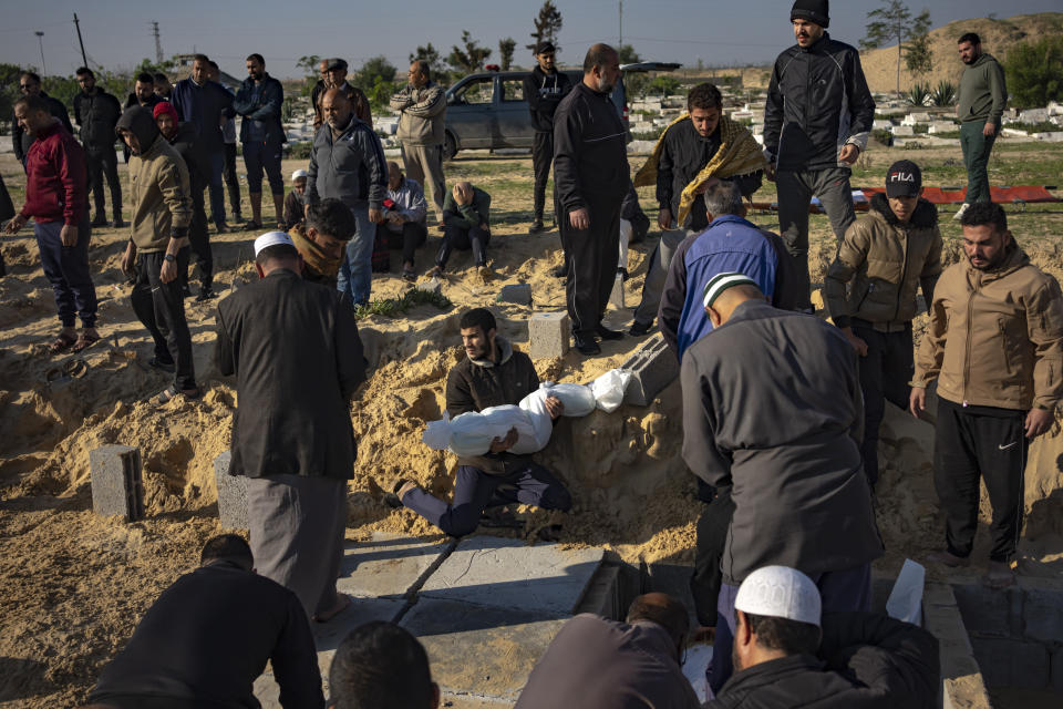 Palestinians bury their relatives killed in the Israeli bombardment of the Gaza Strip, at a cemetery in Rafah, southern Gaza, Tuesday, Dec. 19, 2023. (AP Photo/Fatima Shbair)