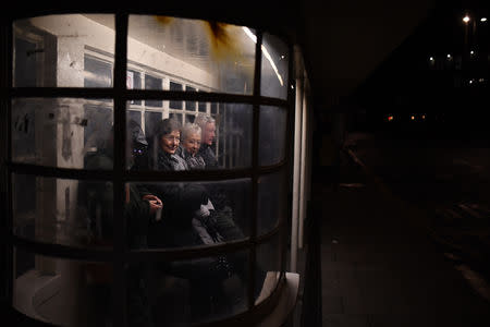 People wait at a bus stop at night in Brighton, Britain March 4, 2019. REUTERS/Clodagh Kilcoyne