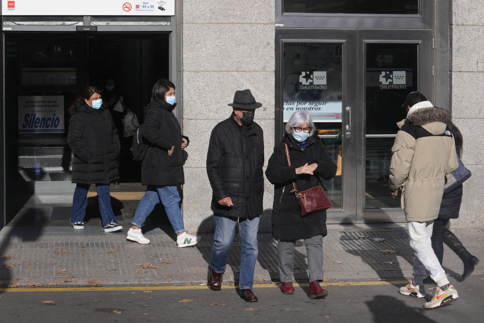 People wearing face masks as a precaution walk at the entrance of a hospital in Madrid, Spain, Monday, Jan. 8, 2024. Regional and national health chiefs are meeting Monday to decide whether to extend mandatory mask—wearing to all health facilities following an epidemic outbreak of flu and other respiratory viruses that are putting a strain on the system. (AP Photo/Paul White)