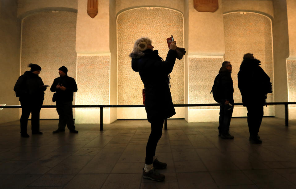 Tourists visit the Pinkas synagogue in Prague, Czech Republic, Thursday, Jan. 24, 2019. A unique collection of some 4,500 drawings by children who were interned at the Theresienstadt concentration camp during the Holocaust now displayed in the Pinkas Synagogue, still attracts attention even after 75 years since their creation. The drawings depict the everyday life as well hopes and dreams of returning home. (AP Photo/Petr David Josek)