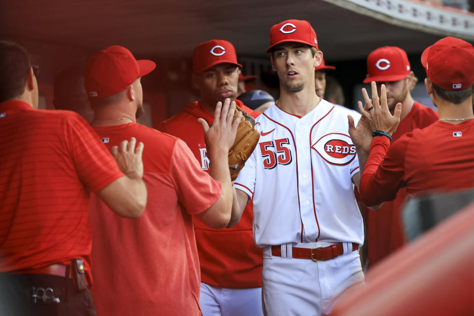 Cincinnati Reds' Brandon Williamson high-fives teammates in the dugout after being pulled during the fifth inning of a baseball game against the St. Louis Cardinals in Cincinnati, Monday, May 22, 2023. AP Photo/Aaron Doster)