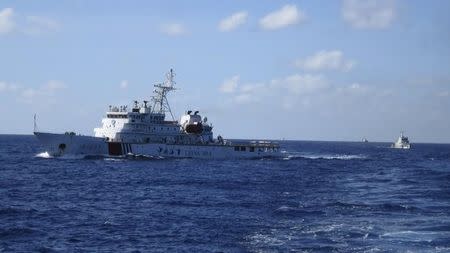 Chinese coastguard ships give chase to Vietnamese coastguard vessels (not pictured) after they came within 10 nautical miles of the Haiyang Shiyou 981, known in Vietnam as HD-981, oil rig in the South China Sea July 15, 2014. REUTERS/Martin Petty