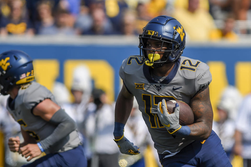 West Virginia running back CJ Donaldson (12) rushes the ball against Towson during the first half of an NCAA college football game in Morgantown, W.Va., Saturday, Sept. 17, 2022. (AP Photo/William Wotring)