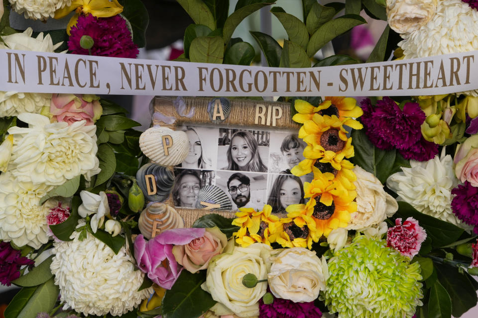 A floral tribute featuring photos of the victims in Saturday's knife attack lays near a crime scene at Bondi Junction in Sydney, Thursday, April 18, 2024. A Sydney shopping mall has been opened to the public for the first time since it became the scene of a mass stabbing in which six people died, while the Australian prime minister has flagged giving citizenship to an immigrant security guard who was injured while confronting the knife-wielding attacker. (AP Photo/Mark Baker)