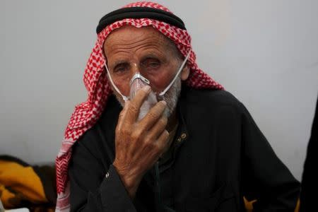 A man breathes through an oxygen mask after what activists said was a chlorine gas attack on Kansafra village at Idlib countryside, Syria May 7, 2015. REUTERS/Abed Kontar/Files