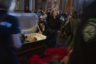 People pay their respects during the funeral of 46-year-old surgeon Natalia Frausher, part of the right-wing 'Hospitallers Medical Battalion,' after she was killed in a bus crash near frontlines, at St. Michael's Golden-Domed Monastery, in Kyiv, Ukraine, Thursday, June 30, 2022. (AP Photo/Nariman El-Mofty)