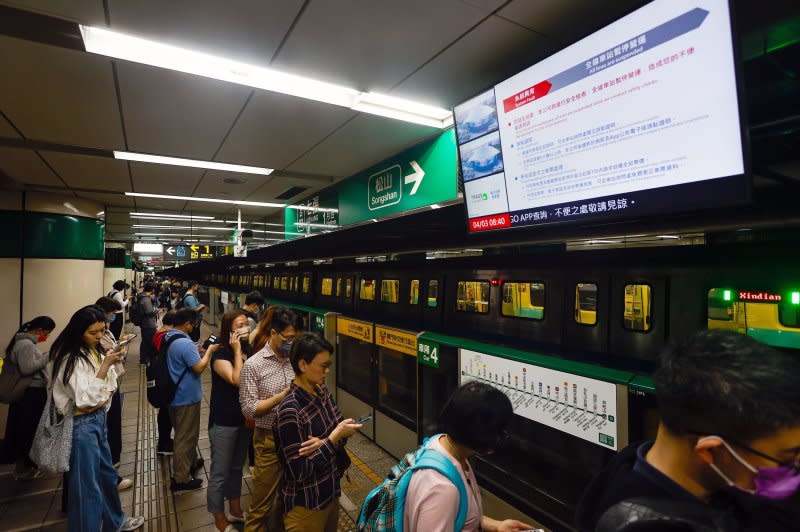 Passengers wait below a screen broadcasting a subway train suspension announcement following a magnitude 7.4 earthquake Wednesday morning local time near Hualien, in a subway station in Taipei, Taiwan. The quake was centered 11 miles south of Hualien City, according to the U.S. Geological Survey. Photo by Daniel Ceng/EPA-EFE